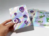 Hologram sticker sheet showing rainbow prismatic reflection with multiple kiss-cut stickers - Sticker Sheet Printing