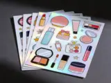 Custom holographic sticker sheet top-down view with visible holographic shimmer - Sticker Sheet Printing